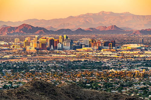 The Phoenix, AZ skyline with mountains in the background.